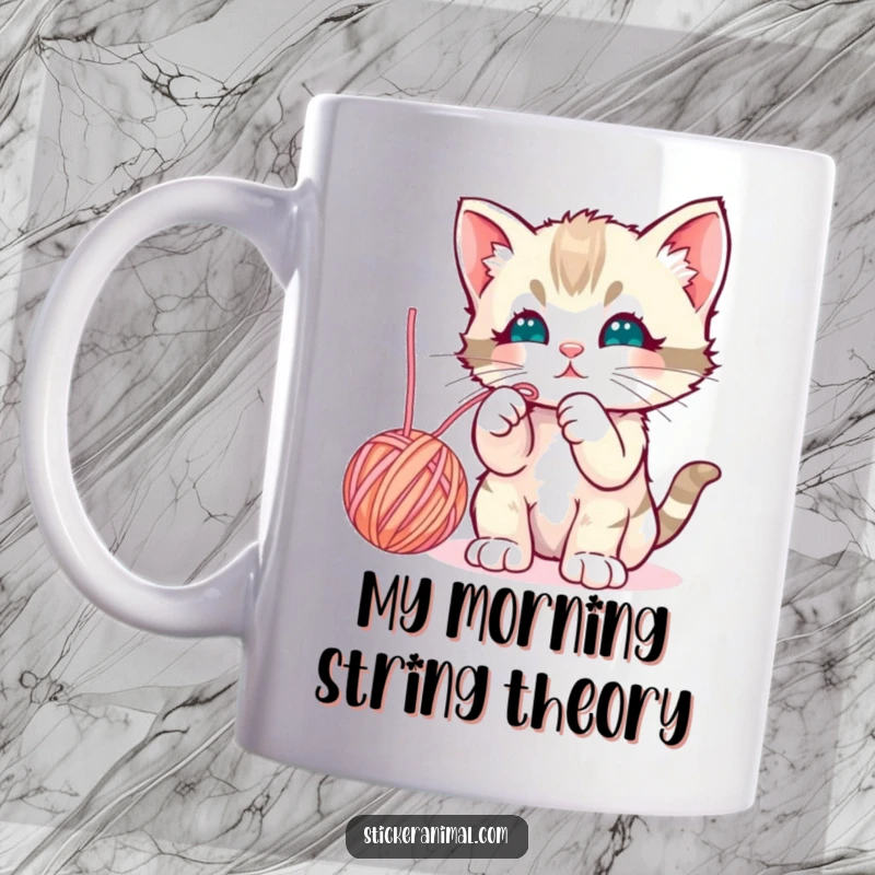 Funny curious kitten batting playfully at a dangling yarn ball on a cheerful mug, celebrating feline fun.