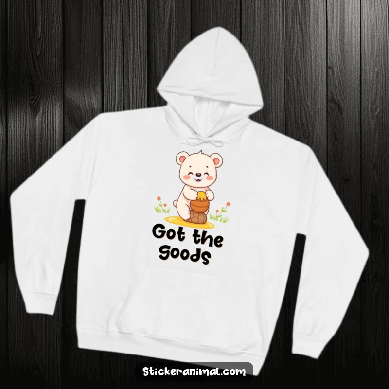 Funny hoodie depicting a happy bear cub balancing a pot of honey, offering cozy comfort and bear-themed sweetness.