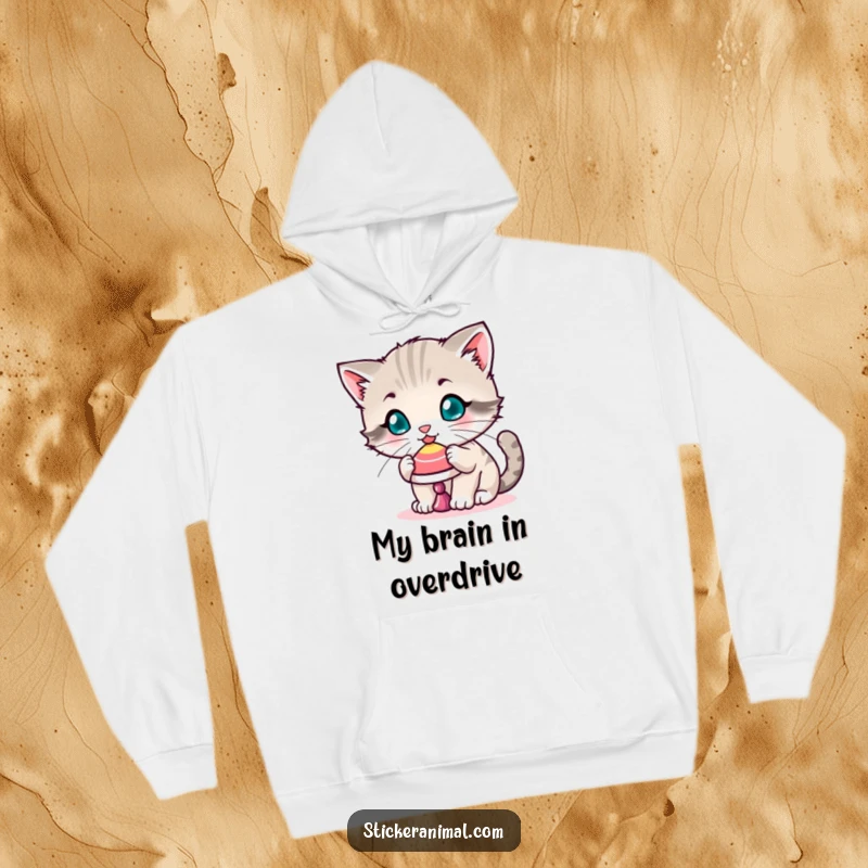 Funny hoodie showing a playful kitten balancing a spinning top on its nose, providing warmth and showcasing adorable feline focus.