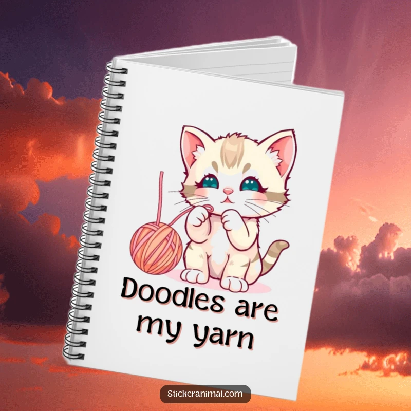 Funny curious kitten batting playfully at a dangling yarn ball, featured on the cover of a cheerful notebook for writing.