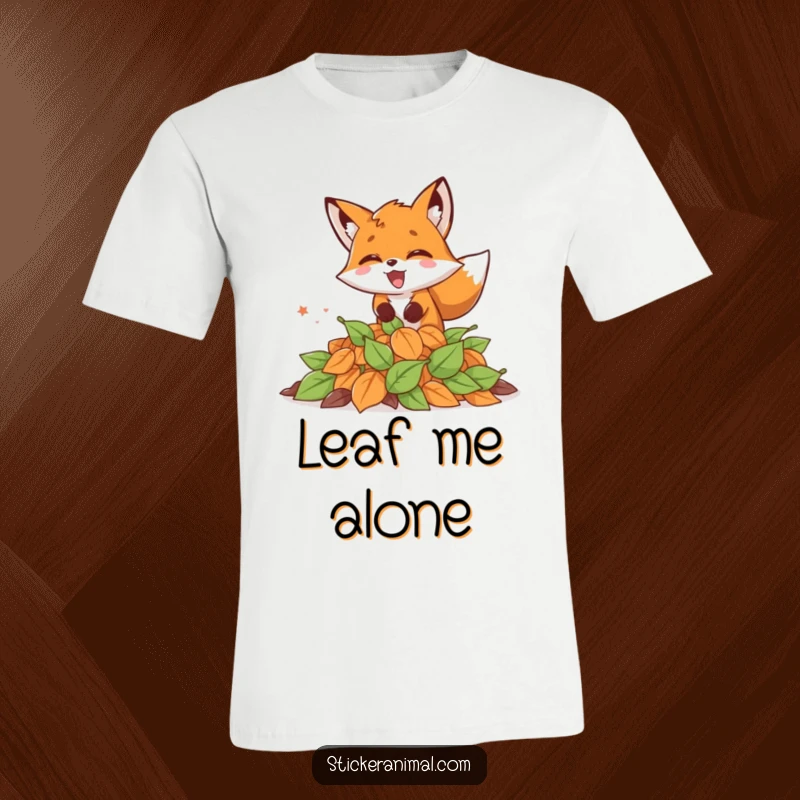 Funny t-shirt featuring a fox leaping excitedly into a mound of fallen leaves, embodying pure autumn joy.